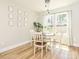 Bright dining area with wood floors, white chairs, and natural light streaming through the window at 2313 Glenwood St, Kannapolis, NC 28083