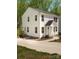 Exterior of a charming two-story home with well-maintained lawns, mulch, and a paved driveway with landscaping at 2313 Glenwood St, Kannapolis, NC 28083