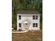 Well-maintained two-story home with white siding, a covered entrance, and landscaping at 2313 Glenwood St, Kannapolis, NC 28083