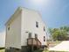 White home featuring a wooden deck, vinyl siding, and ample natural light from its surrounding neighborhood at 2313 Glenwood St, Kannapolis, NC 28083