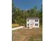 Inviting exterior of a two-story home with lush green surroundings and a paved driveway that leads to the house at 2313 Glenwood St, Kannapolis, NC 28083
