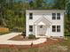 Charming two-story home with white siding, well-manicured landscaping, and a welcoming front porch at 2313 Glenwood St, Kannapolis, NC 28083