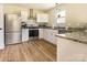 Modern kitchen with stainless steel appliances, granite countertops, and wood flooring at 2313 Glenwood St, Kannapolis, NC 28083