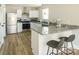 Modern kitchen featuring granite countertops, stainless steel appliances, and a breakfast bar with seating at 2313 Glenwood St, Kannapolis, NC 28083
