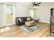 Bright living room features a ceiling fan, natural light, hardwood floors and comfortable seating at 2313 Glenwood St, Kannapolis, NC 28083