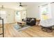Inviting living room with hardwood floors, a comfortable couch, and large windows at 2313 Glenwood St, Kannapolis, NC 28083