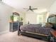 Cozy bedroom with dark furniture, a ceiling fan, carpeted floors, and ample natural light at 2313 Glenwood St, Kannapolis, NC 28083