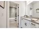 Elegant bathroom with a gray tiled shower, granite countertops, and white cabinets, combining style and functionality at 2329 Paddlers Cove Dr, Clover, SC 29710