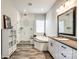 Bright bathroom features a glass shower, separate tub, and double vanity, designed for relaxation at 2329 Paddlers Cove Dr, Clover, SC 29710
