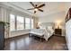 Elegant bedroom with a tray ceiling, ceiling fan, large windows and stylish furnishings create a relaxing retreat at 2329 Paddlers Cove Dr, Clover, SC 29710