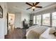 Primary bedroom featuring a ceiling fan, large windows, and dark hardwood flooring, creating a bright atmosphere at 2329 Paddlers Cove Dr, Clover, SC 29710