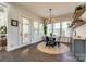 Bright dining area featuring a round woven rug, modern chandelier, and ample natural light from large windows at 2329 Paddlers Cove Dr, Clover, SC 29710