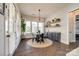 Bright dining area with large windows, modern lighting, and stylish decor, with a round woven rug under the table at 2329 Paddlers Cove Dr, Clover, SC 29710