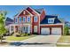 Charming two-story home with a three-car garage, well-maintained landscaping, and a welcoming porch at 2329 Paddlers Cove Dr, Clover, SC 29710