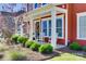 Cozy front porch with rocking chairs, decorative wreath, and well-maintained landscaping at 2329 Paddlers Cove Dr, Clover, SC 29710