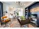 Stylish home office featuring custom built-ins, a modern desk, and comfortable seating area at 2329 Paddlers Cove Dr, Clover, SC 29710