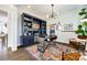 Bright home office with custom shelving, a modern desk, and a decorative rug at 2329 Paddlers Cove Dr, Clover, SC 29710