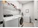Functional laundry room with modern appliances, ample shelving, and storage solutions for efficient chores at 2329 Paddlers Cove Dr, Clover, SC 29710