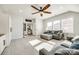Sunlit living room with neutral walls, a ceiling fan, and a gray sectional sofa with a comfortable ottoman at 2329 Paddlers Cove Dr, Clover, SC 29710