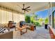 Relaxing covered patio with comfortable seating, ceiling fan, grill, and outdoor view at 2329 Paddlers Cove Dr, Clover, SC 29710