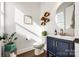 Stylish powder room with a blue vanity, modern fixtures, and decor create an inviting and functional space at 2329 Paddlers Cove Dr, Clover, SC 29710