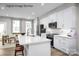 Bright eat-in kitchen features white cabinets, stainless steel appliances, a large island and modern finishes at 2532 Ellen Ave # 1001F, Charlotte, NC 28208