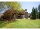 Backyard with pergola, patio, lawn and mature trees providing privacy at 2610 Creek Manor Dr, Waxhaw, NC 28173