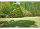Expansive backyard featuring a lush green lawn and a beautiful tree line, providing privacy and a natural setting at 2610 Creek Manor Dr, Waxhaw, NC 28173