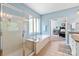 Clean and bright bathroom featuring a glass-enclosed shower and soaking tub at 2610 Creek Manor Dr, Waxhaw, NC 28173