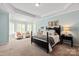 A bright and airy bedroom with large windows and a tray ceiling at 2610 Creek Manor Dr, Waxhaw, NC 28173