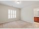 Neutral bedroom features natural light from the window with plantation shutters at 2610 Creek Manor Dr, Waxhaw, NC 28173