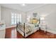 Charming bedroom with decorative iron bed frame, round mirror and bright natural light at 2610 Creek Manor Dr, Waxhaw, NC 28173