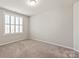 A carpeted bedroom with a window at 2610 Creek Manor Dr, Waxhaw, NC 28173