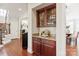 Butler's pantry with wooden cabinets and granite countertop at 2610 Creek Manor Dr, Waxhaw, NC 28173