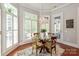 Bright dining room with a stylish chandelier, wood table and chairs, and shuttered windows at 2610 Creek Manor Dr, Waxhaw, NC 28173