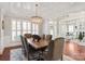 Formal dining room with elegant chandelier, tray ceiling, and hardwood floors for stylish entertaining at 2610 Creek Manor Dr, Waxhaw, NC 28173