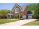 Side view of brick and stone home showing attached garage and driveway at 2610 Creek Manor Dr, Waxhaw, NC 28173