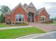 Charming brick home with a stone entrance, large windows, and meticulously landscaped grounds at 2610 Creek Manor Dr, Waxhaw, NC 28173