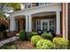 Inviting front porch with stone columns and white trim, perfect for relaxing and enjoying the outdoors at 2610 Creek Manor Dr, Waxhaw, NC 28173