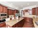 A beautiful kitchen with rich cabinetry, granite countertops, and stainless steel appliances at 2610 Creek Manor Dr, Waxhaw, NC 28173