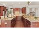 Spacious kitchen featuring custom wood cabinetry, granite countertops, and hardwood floors at 2610 Creek Manor Dr, Waxhaw, NC 28173