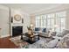 Elegant living room with a fireplace, a large clock and an array of comfortable seating at 2610 Creek Manor Dr, Waxhaw, NC 28173