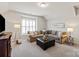 A cozy living room with comfortable seating, a stylish ottoman, and ample lighting at 2610 Creek Manor Dr, Waxhaw, NC 28173