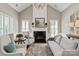 Bright living room features a fireplace and large windows with shutters for natural light at 2610 Creek Manor Dr, Waxhaw, NC 28173