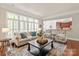 Bright living room with a large window, comfortable sofa and chairs that face an open kitchen at 2610 Creek Manor Dr, Waxhaw, NC 28173