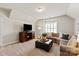 A cozy living room with comfortable seating, a stylish ottoman, and ample lighting at 2610 Creek Manor Dr, Waxhaw, NC 28173