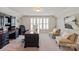 Home office with neutral walls and carpet features a large window with plantation shutters at 2610 Creek Manor Dr, Waxhaw, NC 28173