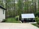 View of the backyard with well kept lawn, greenhouse, and fenced in area at 2656 Lee Lawing Rd, Lincolnton, NC 28092