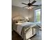 Serene bedroom with a comfortable bed, soft lighting, and a view of the surrounding greenery through a large window at 2656 Lee Lawing Rd, Lincolnton, NC 28092