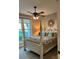 Comfortable bedroom featuring a four poster bed, fan, and beautiful window view at 2656 Lee Lawing Rd, Lincolnton, NC 28092